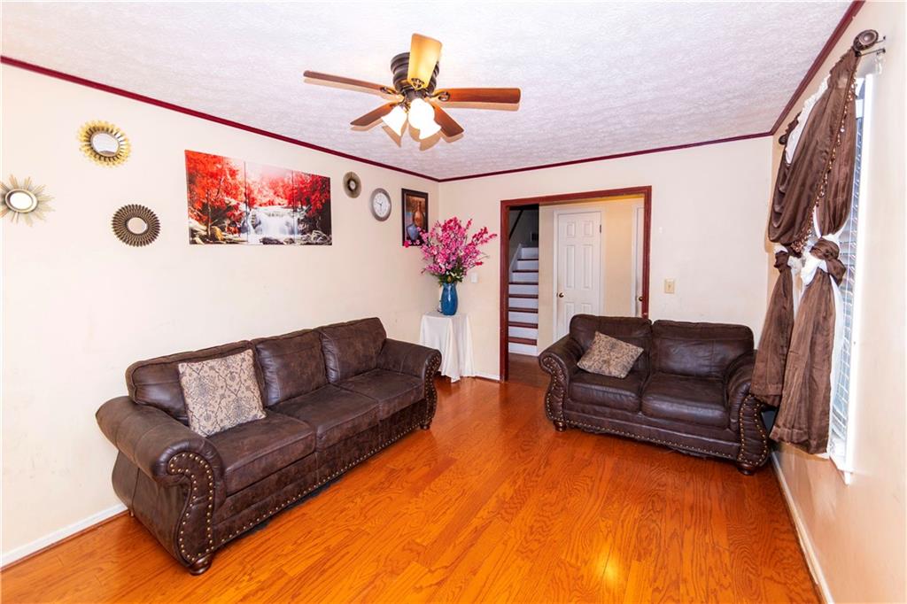 775 Shannon Way Lawrenceville, GA 30044 - Photo 10 of 24 a living room with furniture and a flat screen tv