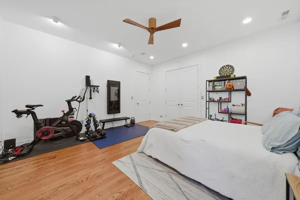a bed room with a bed and a ceiling fan