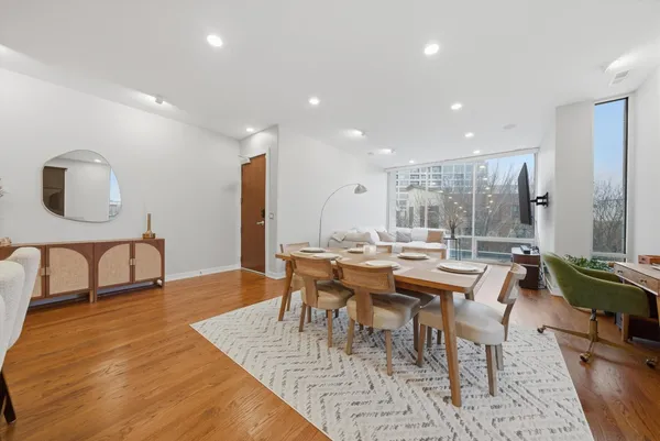 a dining room with furniture and wooden floor