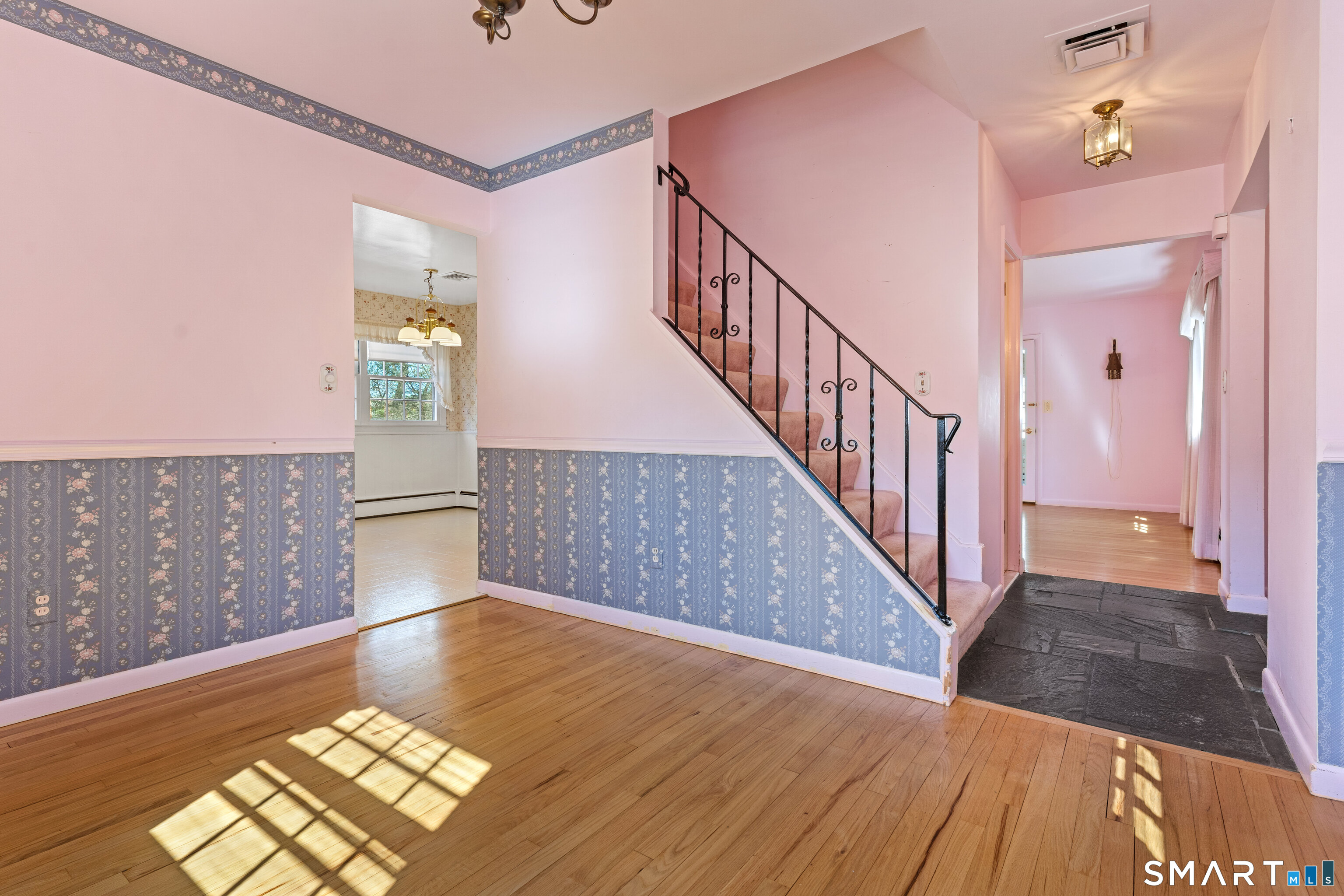 251 Shelter Rock Road Fairfield, CT 06825 - Photo 10 of 38 a view of a hallway with wooden floor and staircase