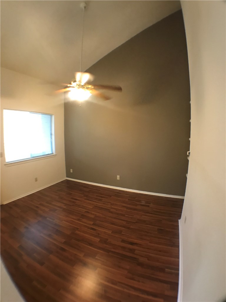 4411 Guadalupe Street, Unit 16 Austin, TX 78751 - Photo 4 of 12 a view of an empty room with wooden floor and a window