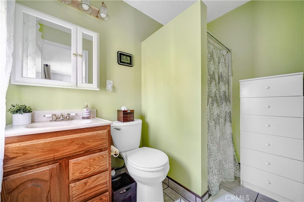 8201 Page Street Buena Park, CA 90621 - Photo 14 of 32 a bathroom with a sink a toilet and a mirror