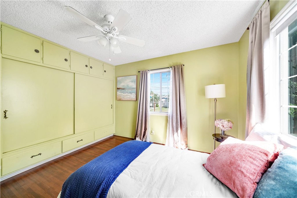 8201 Page Street Buena Park, CA 90621 - Photo 16 of 32 a bedroom with a bed and a chandelier