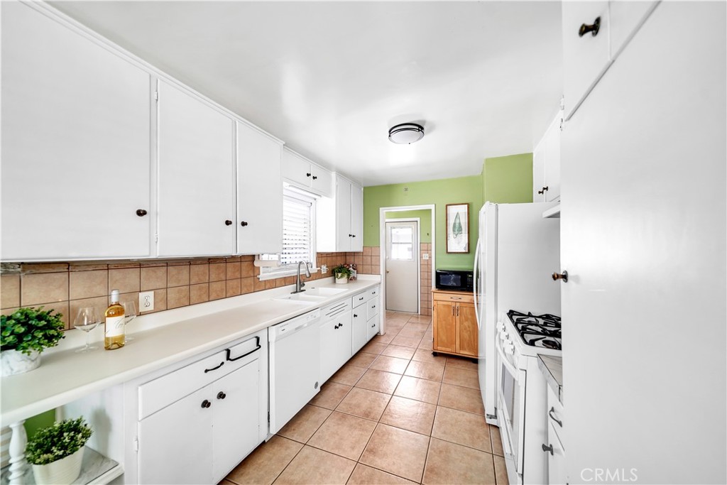8201 Page Street Buena Park, CA 90621 - Photo 10 of 32 a large kitchen with cabinets and stainless steel appliances