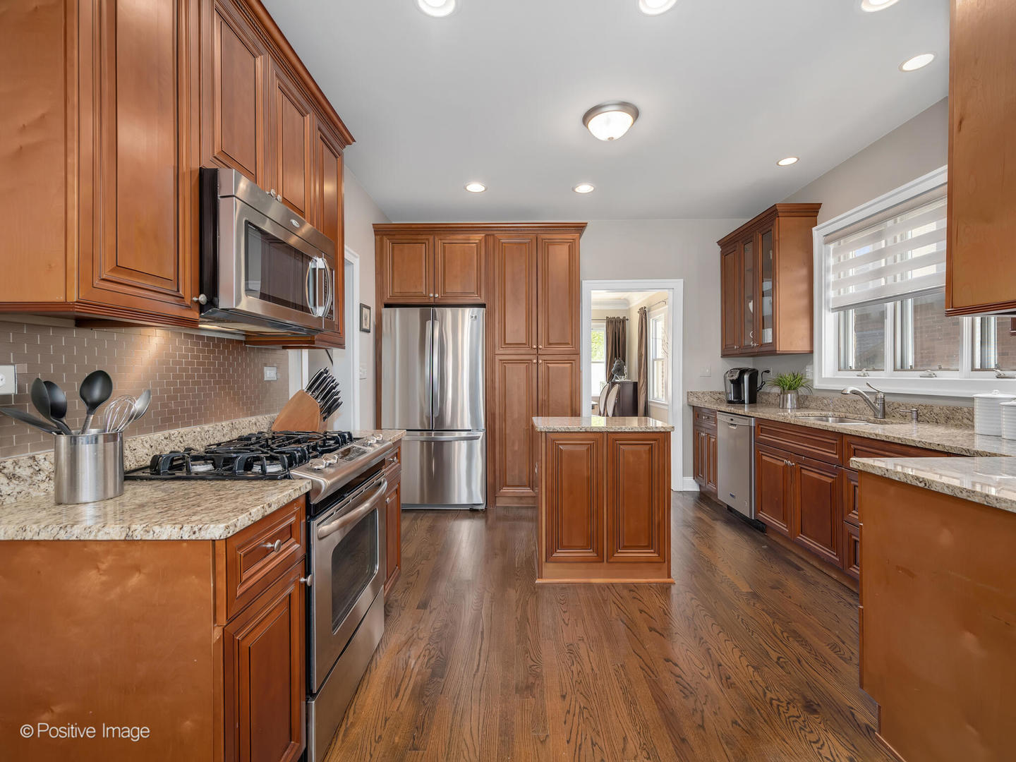 302 Southcote Road Riverside, IL 60546 - Photo 13 of 40 a kitchen with stainless steel appliances granite countertop a stove a sink dishwasher a refrigerator white cabinets and wooden floor