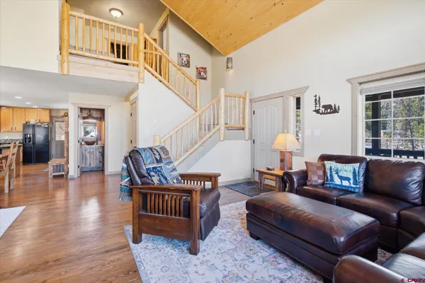 a front view of a house with a yard covered with snow and trees