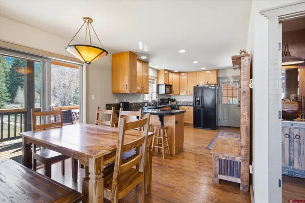 an aerial view of a house with a yard and tree s