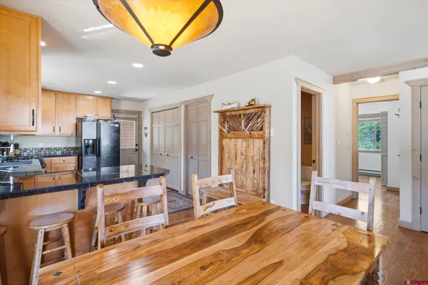 a bathroom with a granite countertop sink a toilet a mirror and shower