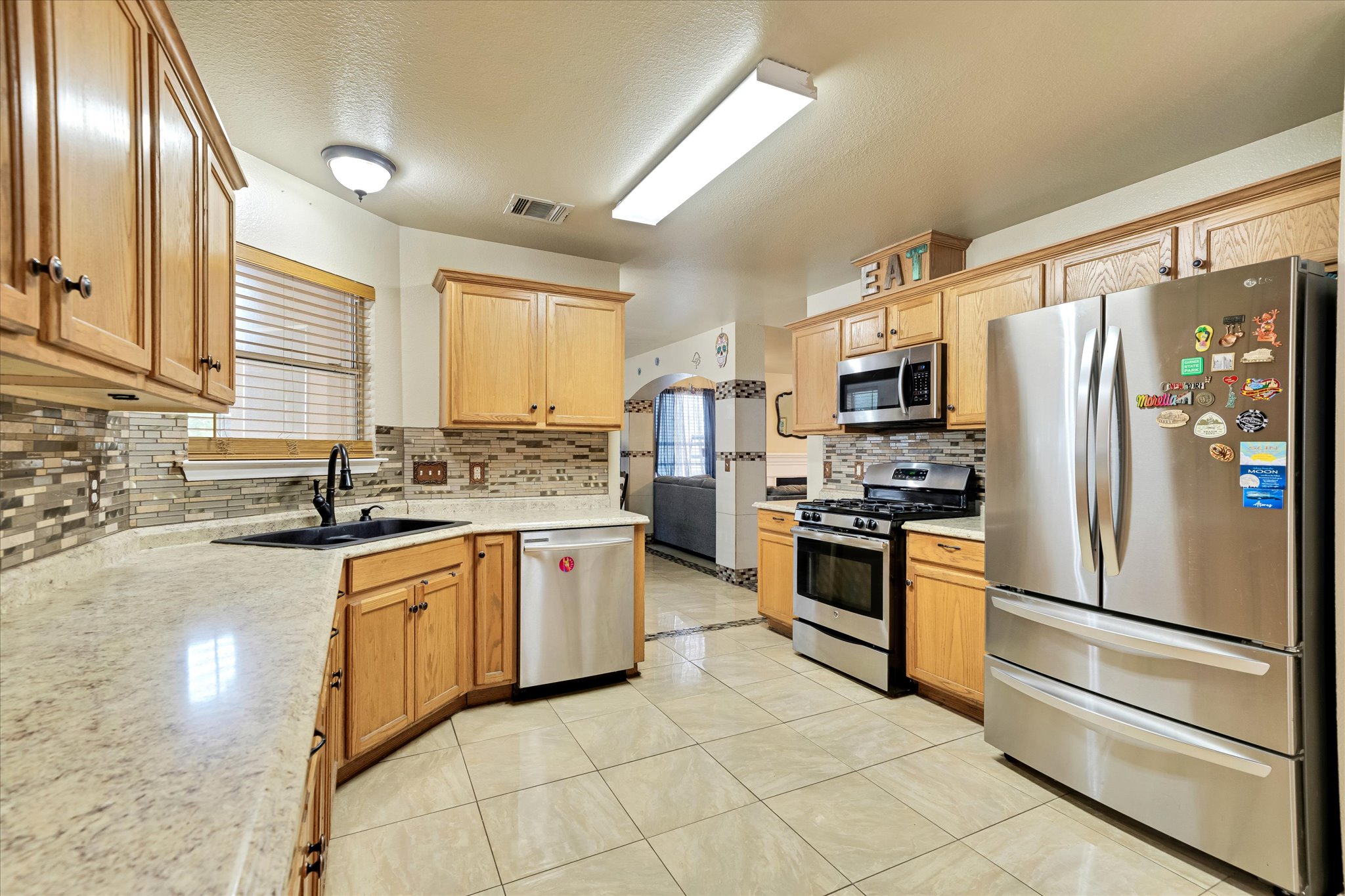 2601 Highcloud Drive Lockhart, TX 78644 - Photo 16 of 30 a kitchen with granite countertop stainless steel appliances a refrigerator sink and microwave