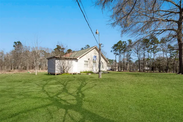 a house with green field in front of it