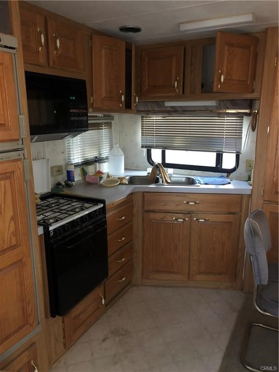 58160 Bliss Road Anza, CA 92539 - Photo 4 of 24 a kitchen with stainless steel appliances granite countertop a stove a sink and a microwave
