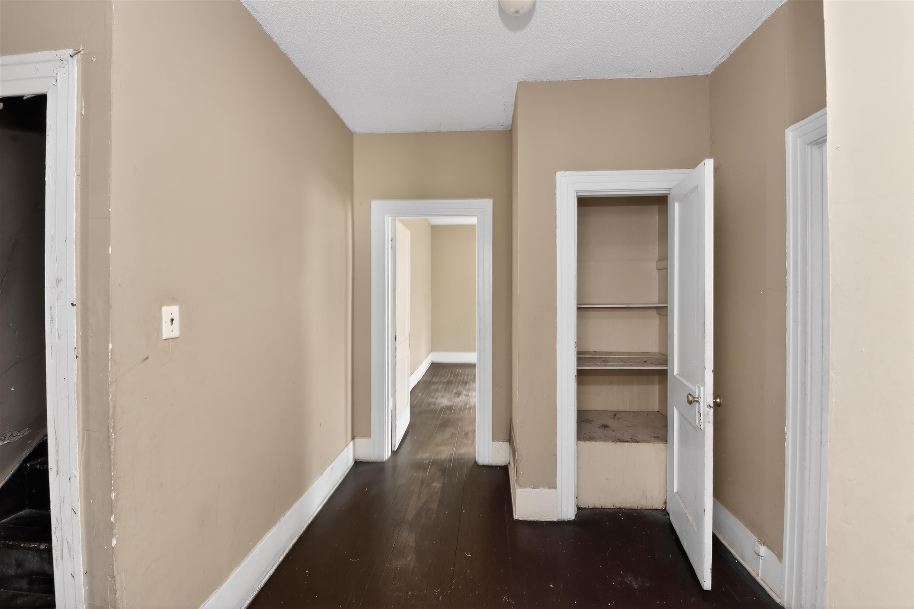 810 Hale Road Memphis, TN 38116 - Photo 24 of 30 Interior hallway featuring dark wood-finish flooring, neutral-toned walls, and white trim
