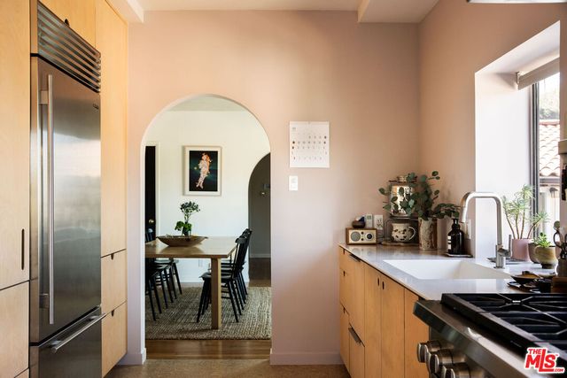 a kitchen with stainless steel appliances dining table and chairs
