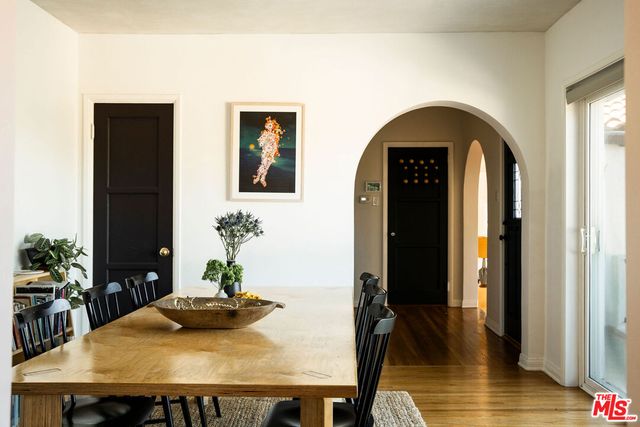 a dining room with furniture and wooden floor