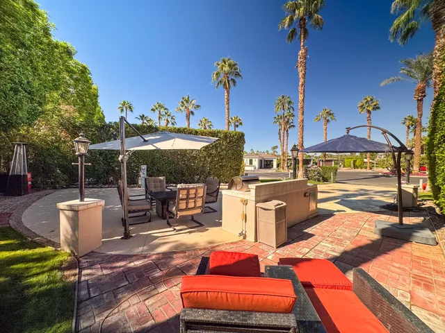 a view of open kitchen with a stove and a microwave