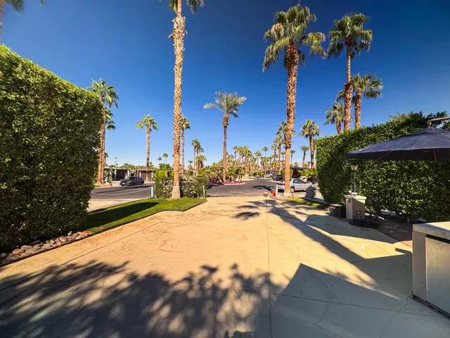a view of a swimming pool with sitting area and garden