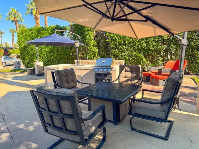 a view of an outdoor sitting area with furniture and backyard