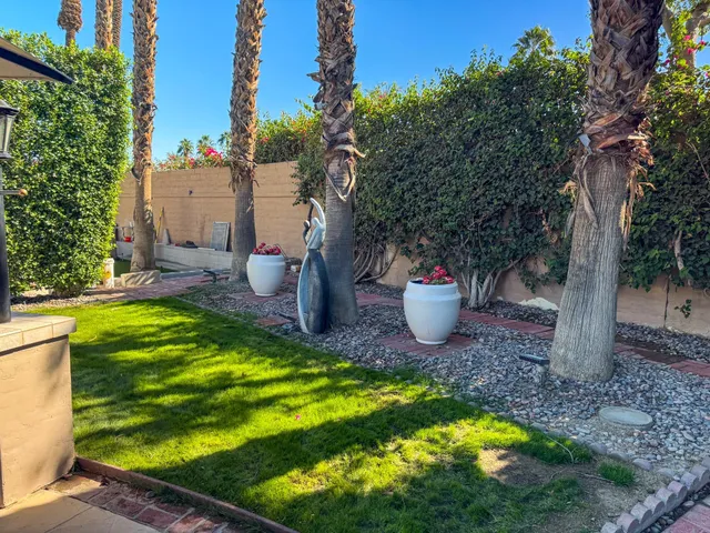 a view of a backyard with table and chairs and a fire pit