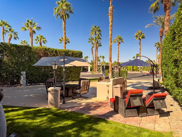 an outdoor space with furniture and umbrella