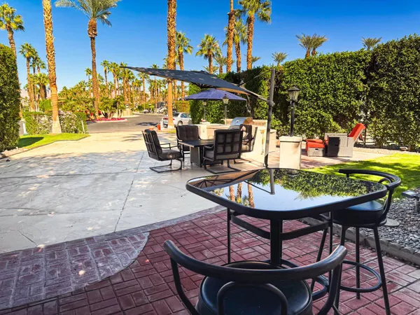 a view of a chairs and table in patio