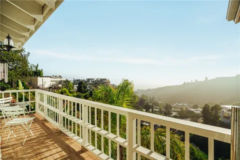 a kitchen with stainless steel appliances granite countertop a white cabinets and a stove top oven