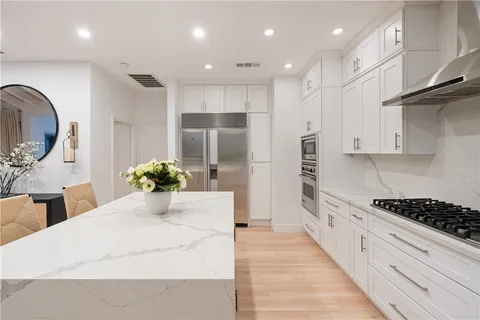a bathroom with a granite countertop toilet sink and mirror