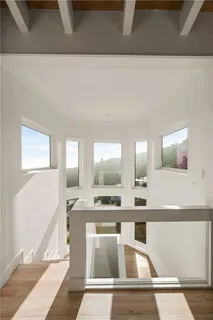 a bedroom with furniture and a large window