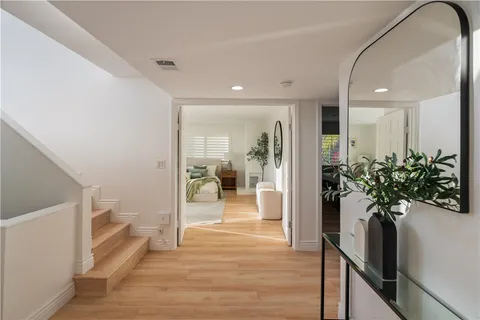 a spacious bedroom with a bed a couch and a window