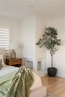 a bedroom with a bed and painting on the wall