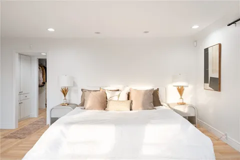 a bathroom with a double vanity sink and mirror with bathtub