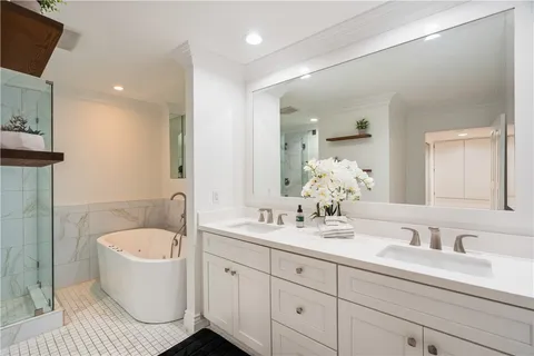 a bathroom with double sink and a mirror