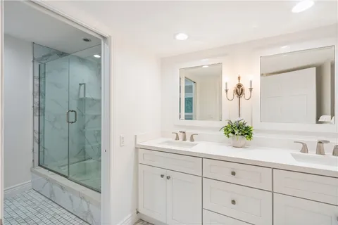 a kitchen with a dining table chairs and white cabinets