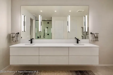 a bathroom with a sink vanity and mirror