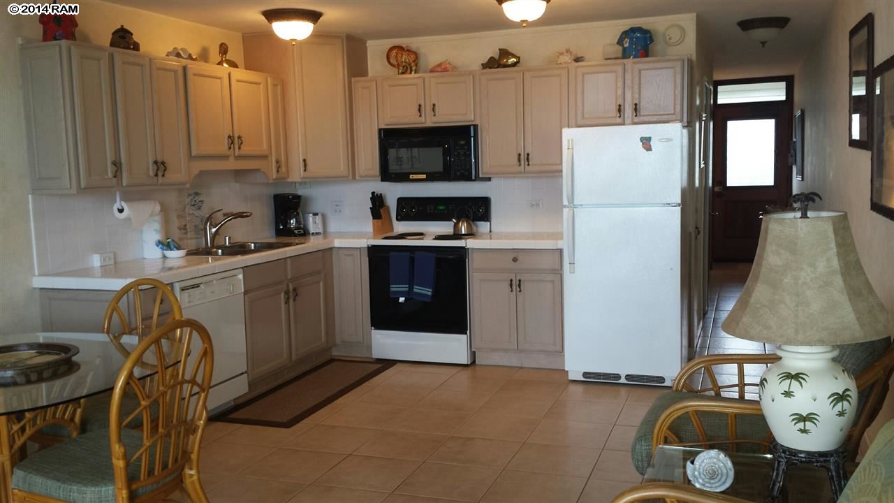 1310 Uluniu Road, Unit 317 Kihei, HI 96753 - Photo 1 of 21 a kitchen with stainless steel appliances a refrigerator a sink a stove and cabinets