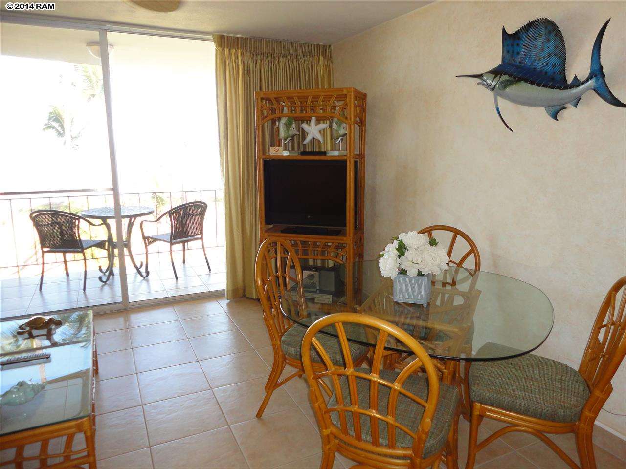 1310 Uluniu Road, Unit 317 Kihei, HI 96753 - Photo 7 of 21 a view of a dining room with furniture and chandelier