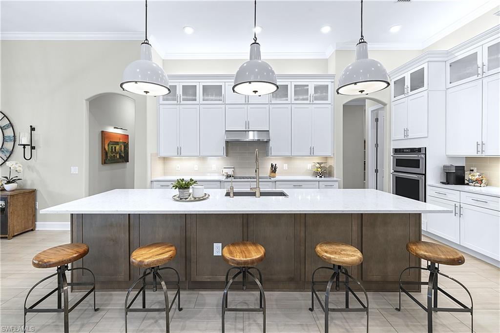 19074 Elston Way Estero, FL 33928 - Photo 1 of 50 a kitchen with cabinets and chairs