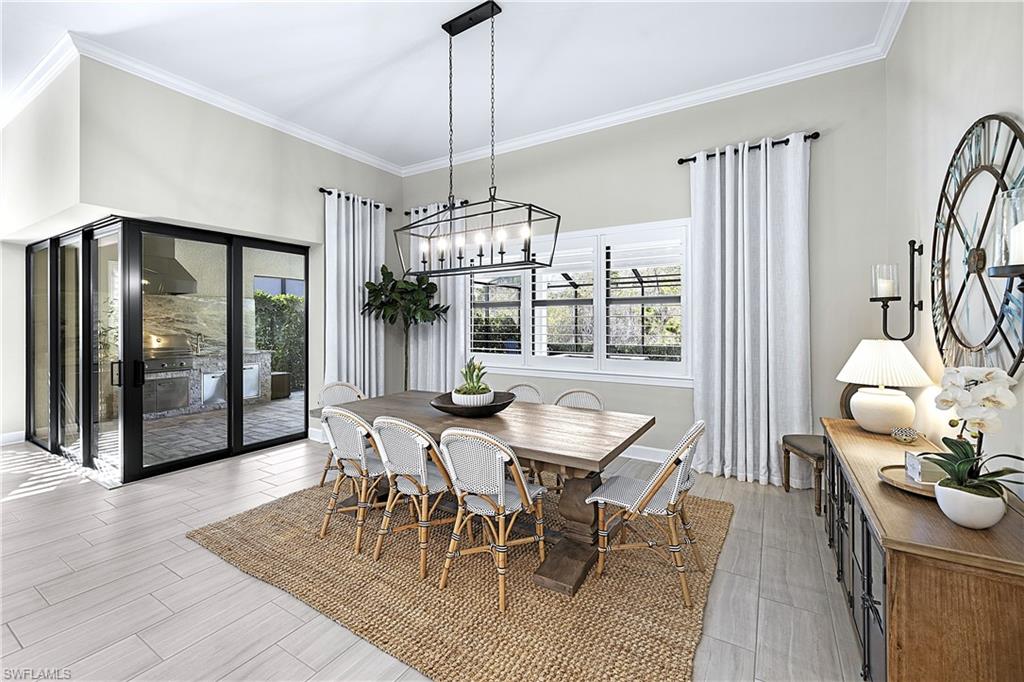 19074 Elston Way Estero, FL 33928 - Photo 11 of 50 a dining room with furniture a chandelier and wooden floor