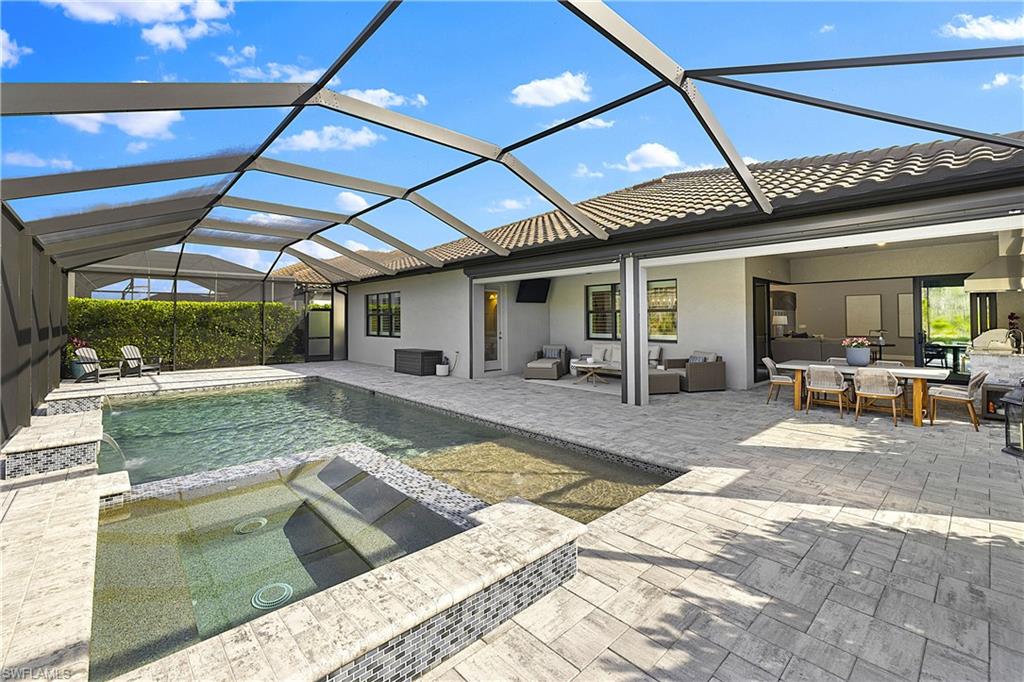 19074 Elston Way Estero, FL 33928 - Photo 15 of 50 a view of a patio with table and chairs with wooden floor and fence