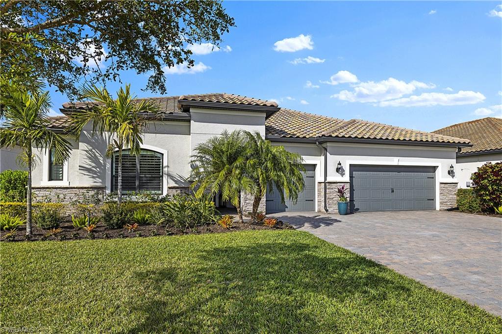 19074 Elston Way Estero, FL 33928 - Photo 17 of 50 a view of a house with a yard and palm trees