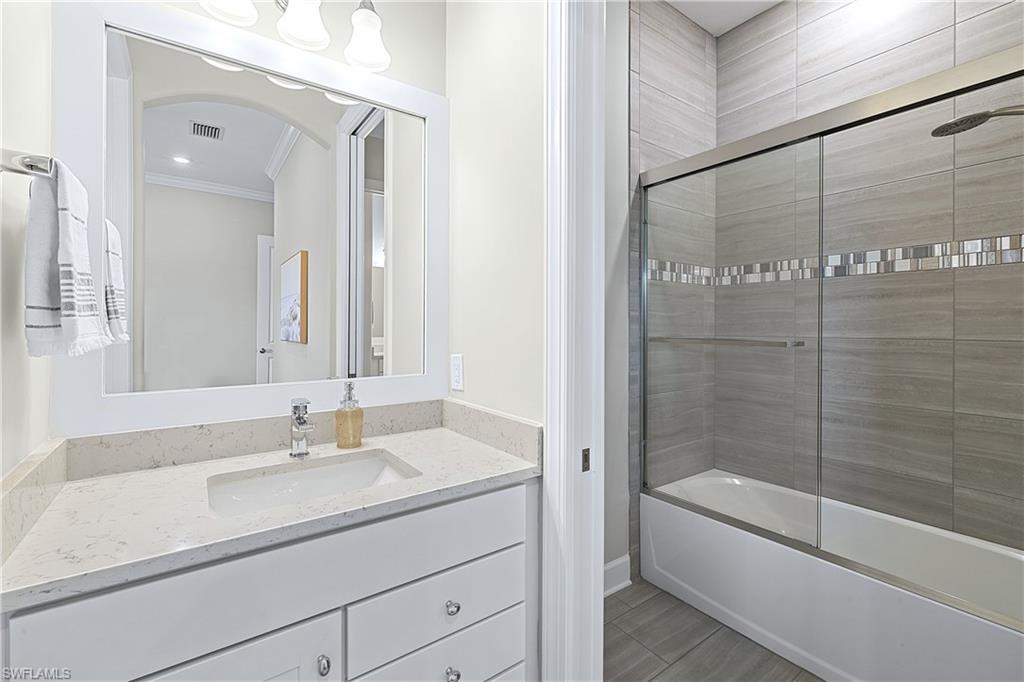 19074 Elston Way Estero, FL 33928 - Photo 20 of 50 a bathroom with a shower sink and mirror