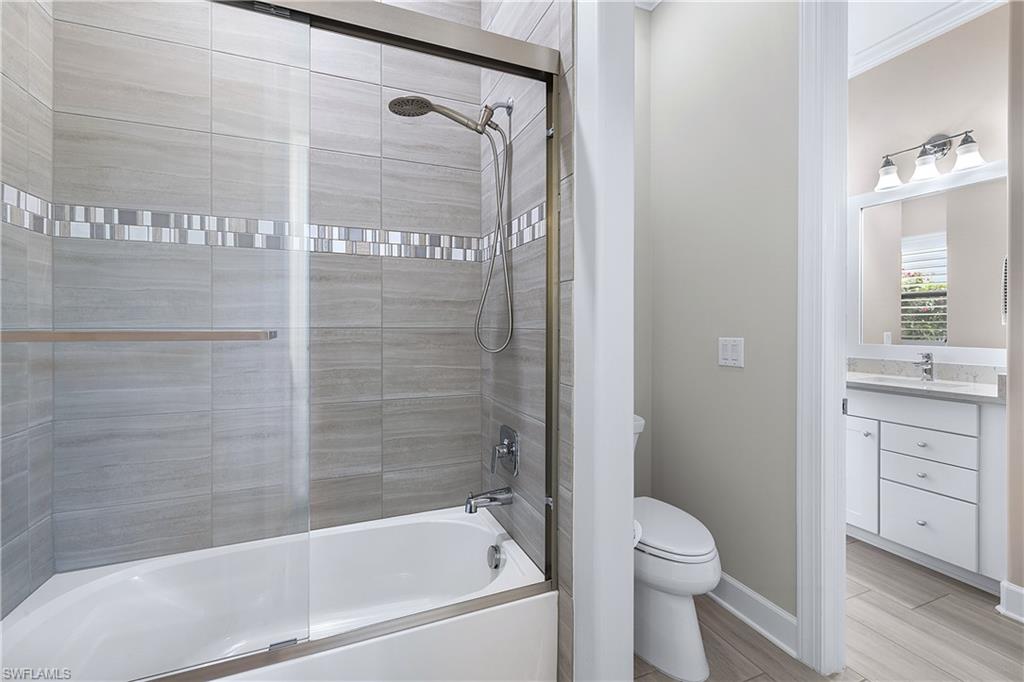 19074 Elston Way Estero, FL 33928 - Photo 21 of 50 a bathroom with a granite countertop bathtub shower sink vanity and toilet
