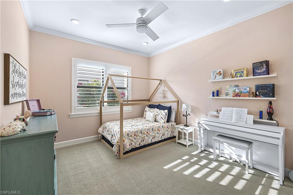 19074 Elston Way Estero, FL 33928 - Photo 23 of 50 a bedroom with a bed and a chandelier