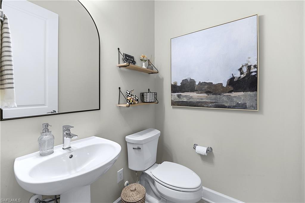 19074 Elston Way Estero, FL 33928 - Photo 24 of 50 a bathroom with a toilet sink and mirror