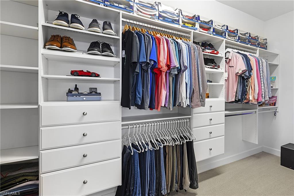 19074 Elston Way Estero, FL 33928 - Photo 27 of 50 a view of walk in closet with clothes and shoes