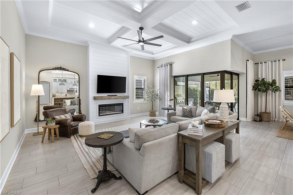 19074 Elston Way Estero, FL 33928 - Photo 32 of 50 a living room with fireplace furniture and a flat screen tv