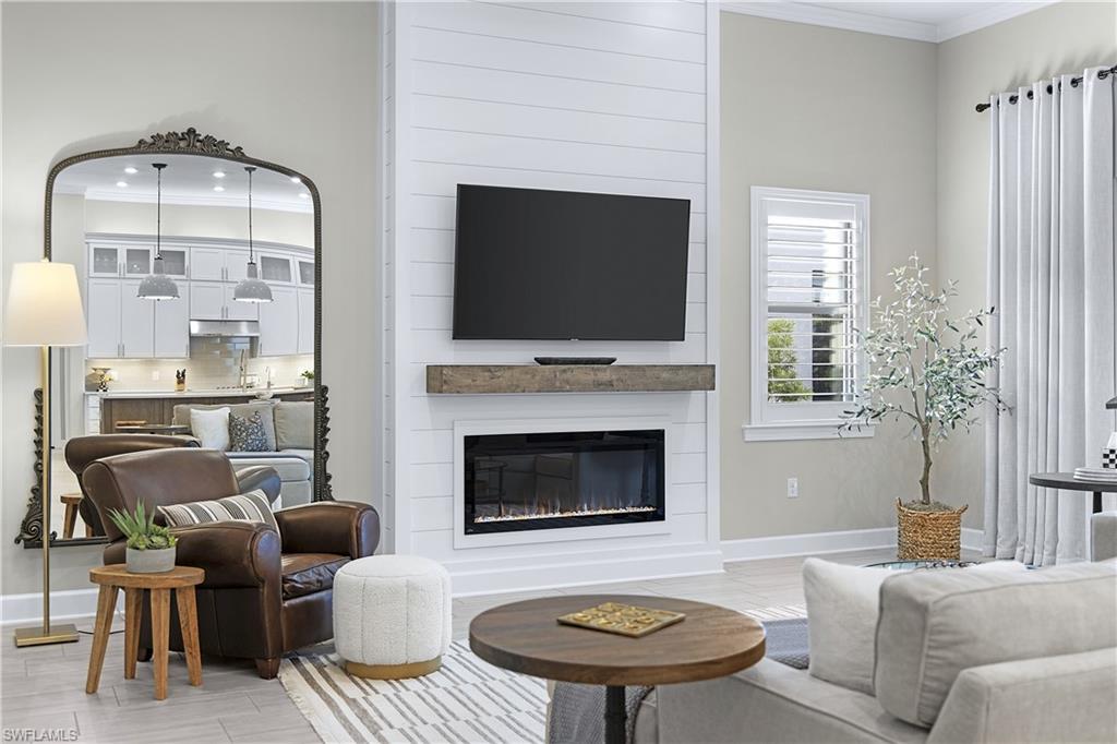 19074 Elston Way Estero, FL 33928 - Photo 33 of 50 a living room with furniture a fireplace and a flat screen tv