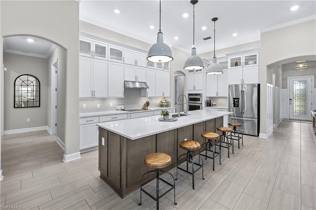 19074 Elston Way Estero, FL 33928 - Photo 36 of 50 a large kitchen with a table and chairs