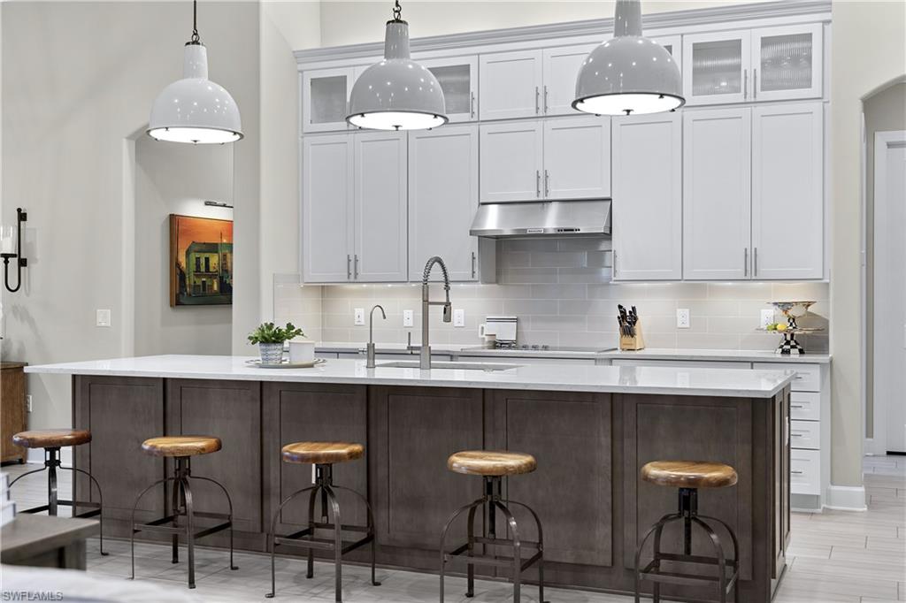 19074 Elston Way Estero, FL 33928 - Photo 37 of 50 a kitchen with stainless steel appliances a sink and cabinets