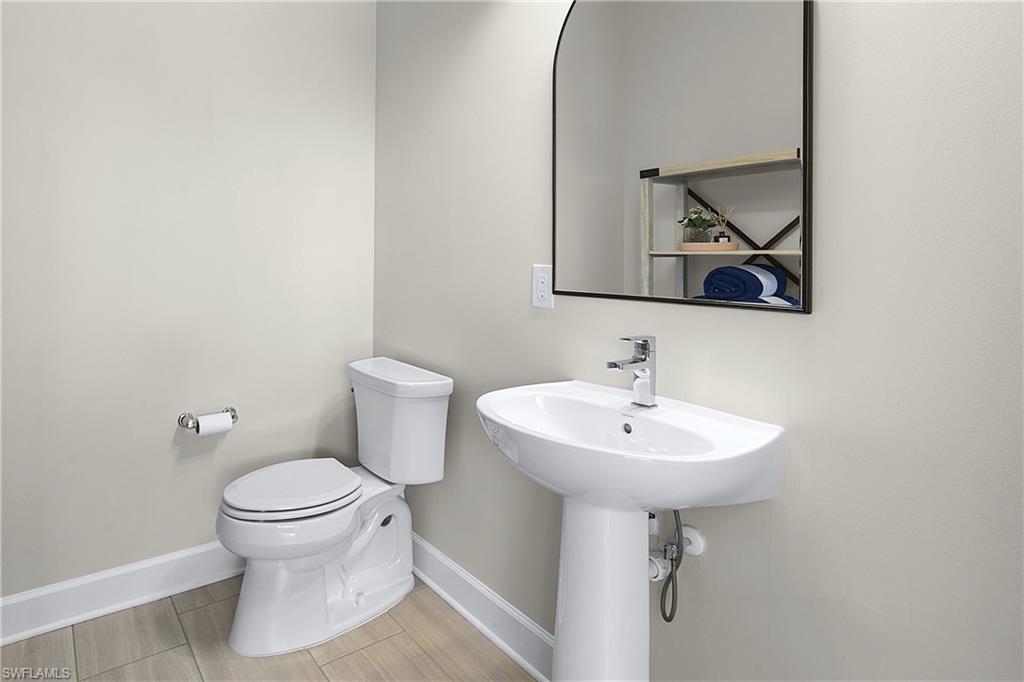 19074 Elston Way Estero, FL 33928 - Photo 42 of 50 a bathroom with a sink toilet and mirror