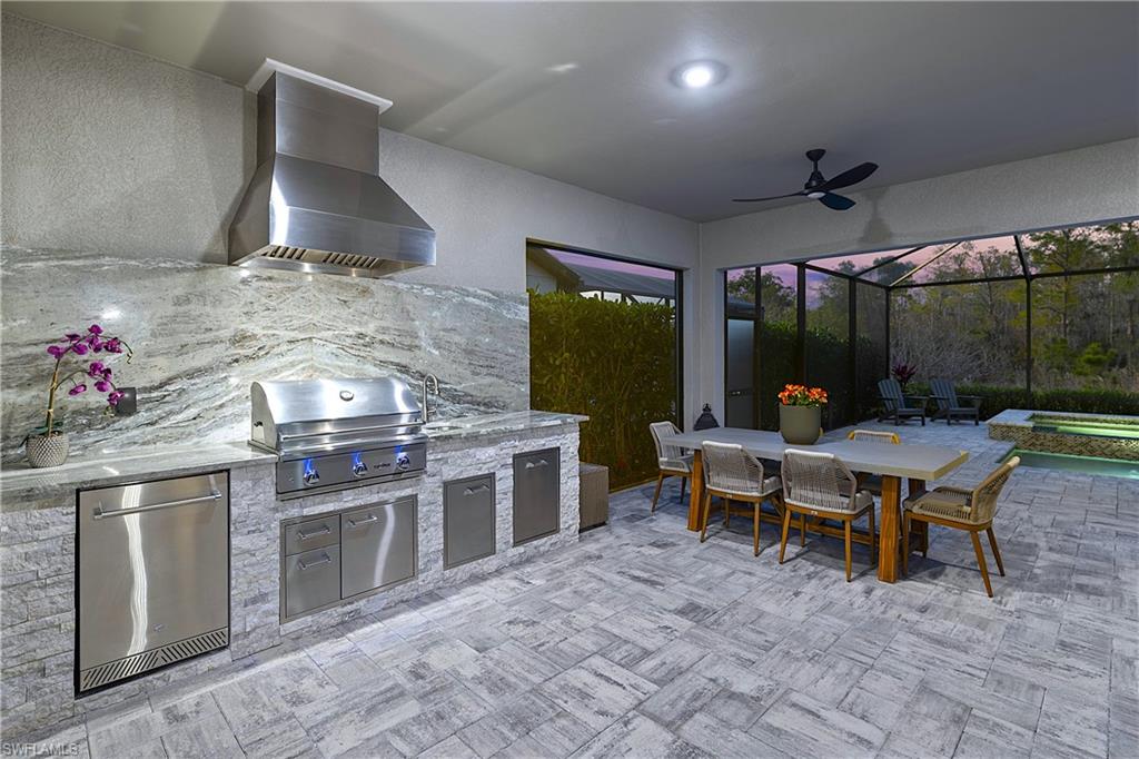 19074 Elston Way Estero, FL 33928 - Photo 43 of 50 a open kitchen with stainless steel appliances granite countertop a stove a sink a dining table and chairs